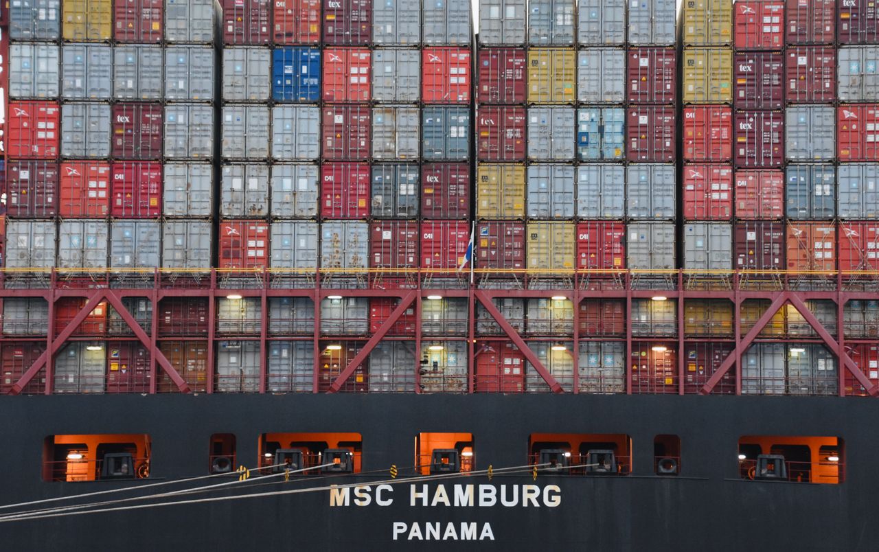 Stacked shipping containers aboard MSC Hamburg at the bustling port of Hamburg.